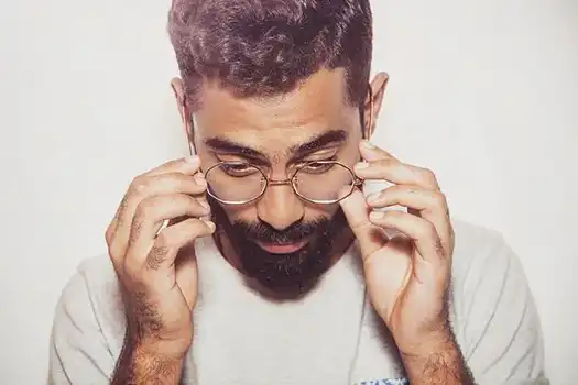 Man adjusting his frames